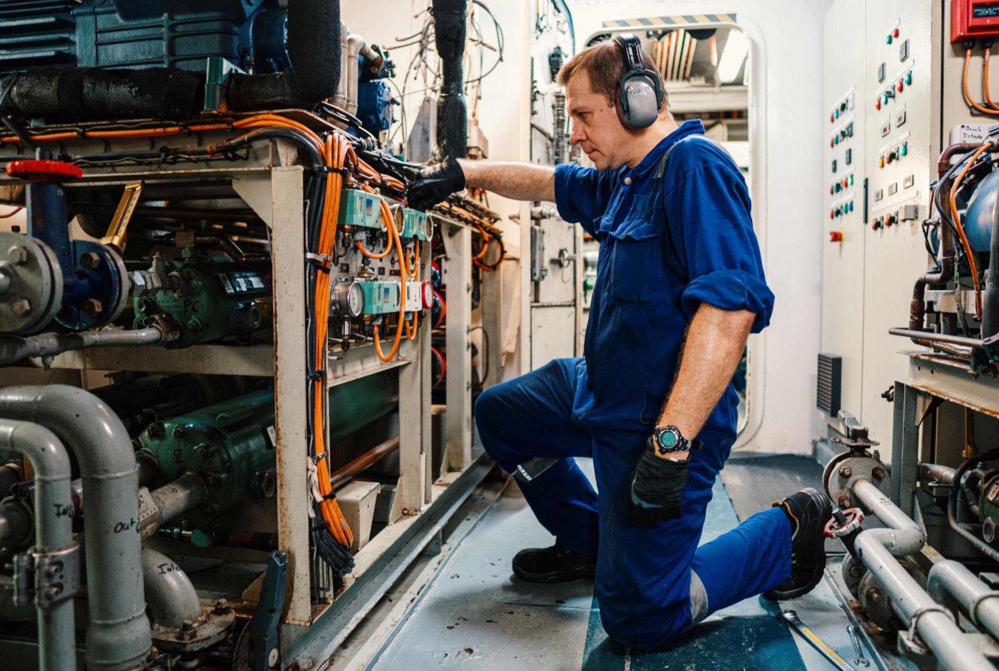 Technical engineer inspecting vessel machinery